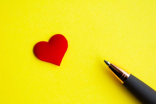 Heart shape and pen on yellow background cover with customizable space for text or message. Love concept and copy space