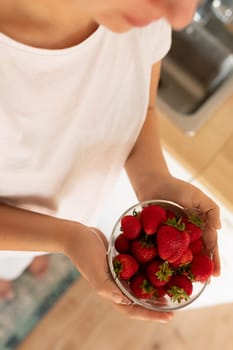 juicy strawberries in the hands of a woman.