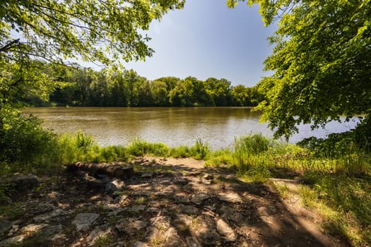 Beautiful small square next to river for rest next to footpath at beautiful green surroundings