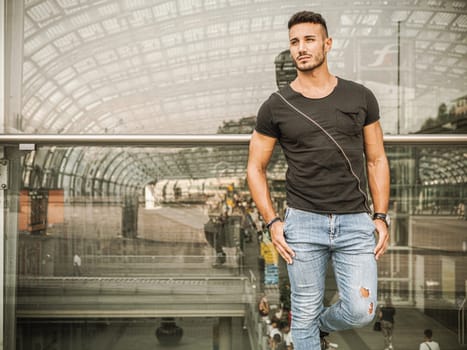 A man standing in front of a glass wall