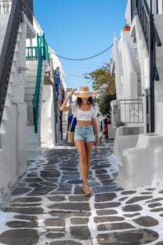 Young woman with shorts and hat on the streets of Mykonos