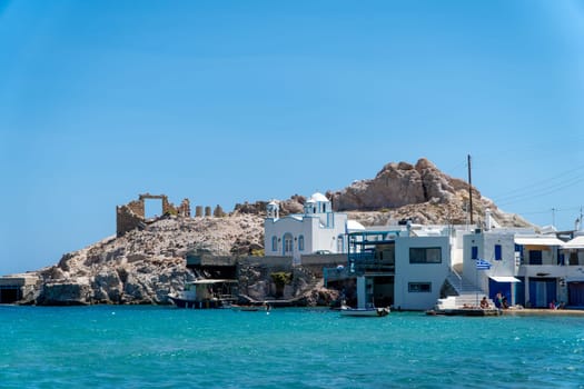 Stone door and Church of Agios Nikolaos in Milos