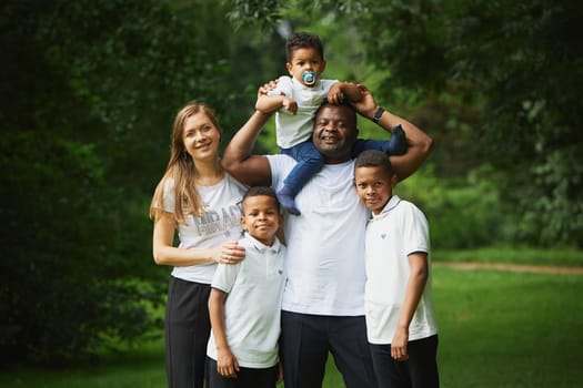 Tilst, Denmark, 12th of August, 2023: Interracial family walking in the forest