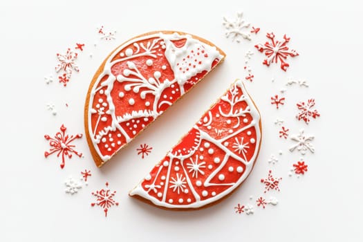 A split gingerbread cookie with vibrant red icing and festive decorations, perfect for holiday themes.