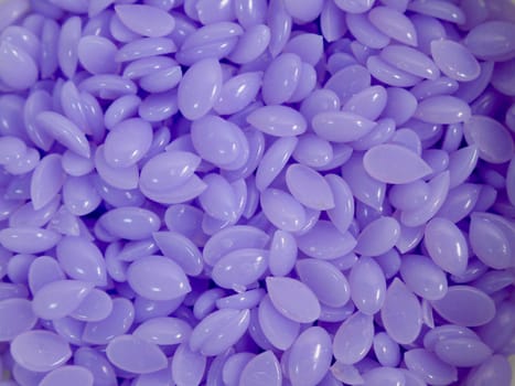 Background Purple wax in depilatory granules close-up
