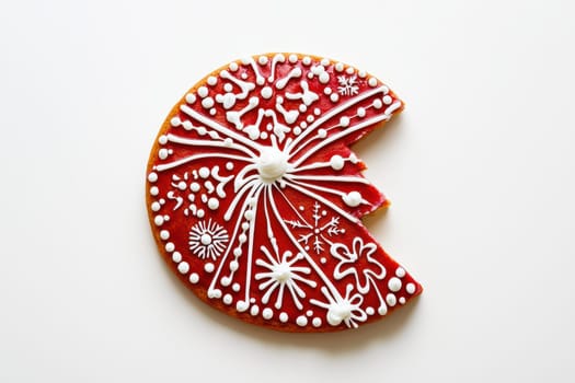 A beautifully decorated red cookie featuring intricate white icing designs, perfect for holiday celebrations.