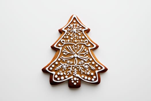 A beautifully decorated gingerbread Christmas tree cookie, adorned with vibrant icing, perfect for the holiday season