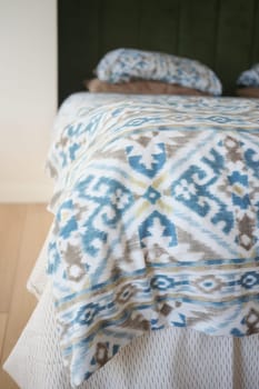 A stylish bed with a geometric blanket and soft pillows offers a cozy decor for the room