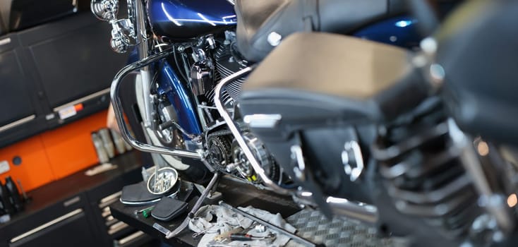 Motorcycle and parts in the garage kitchen, close-up. Pedal replacement, transmission tuning, upgrade motorbike