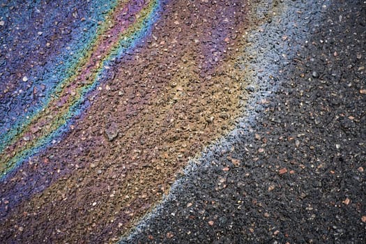 Attention-grabbing oil stain showing vibrant hues on asphalt pavement