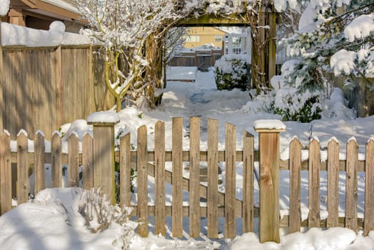 Wooden fence and gate of residential area entrance on bright winter day in Vancouver, Canada