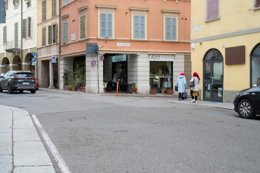 Cremona, Italy - November 20th 2024 Two women walking on via solferino crossing via stefano ceretti in cremona, italy