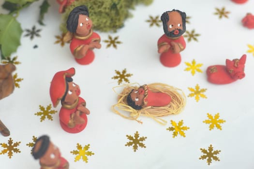 Ceramic red figurines of Joseph, Mary, Jesus of a nativity scene Christmas creche