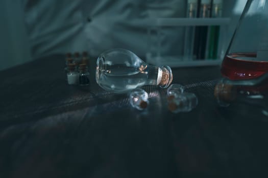 A scientist in a laboratory conducts an experiment with test tubes filled with vibrant liquids, surrounded by various lab equipment. The image showcases professional scientific research