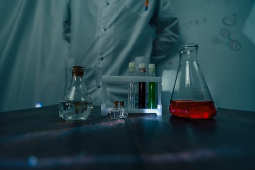 A scientist in a laboratory conducts an experiment with test tubes filled with vibrant liquids, surrounded by various lab equipment. The image showcases professional scientific research