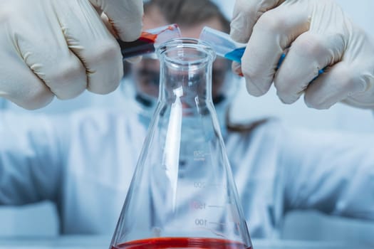 A scientist examines a liquid in a test tube in a laboratory, surrounded by various lab equipment. The image emphasizes the precision and concentration of scientific research