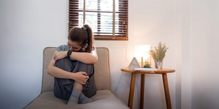 Young Asian woman in bedroom feeling sad tired and worried suffering depression in mental health.