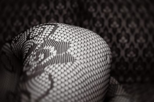 A close-up view showcases the intricate patterns of black lace against a textured surface, creating an elegant visual contrast.