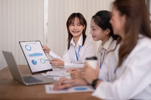 Team employee collaboration discussing working analyzing with financial data and marketing growth report graph in team, brainstorming to strategy planning making profit of company.