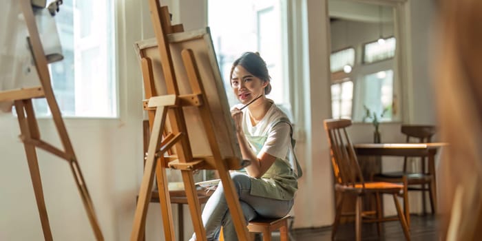 Talented Female Artist Working on a artist lifestyle. painting hobby. woman drawing beautiful watercolor design.