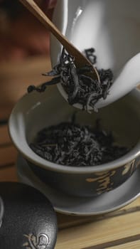 In this serene moment, loose leaf tea is being prepared, beautifully highlighting the elegant, delicate brewing process