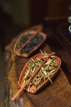 Beautifully arranged herbal ingredients in unique clay bowls, showcasing natural textures and colors.