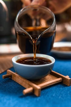A closeup of steaming coffee being poured into a cup, showcasing its rich color and the brewing process