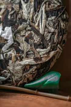 This closeup image shows detailed textures of natural materials, featuring a beautiful green decorative element