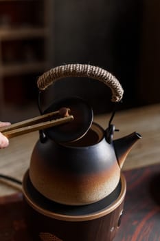 A beautifully crafted Japanese teapot elegantly displayed in use, showcasing the rich traditional tea culture