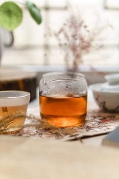 A warm glass of aromatic tea surrounded by lush nature and a truly serene atmosphere that brings comfort