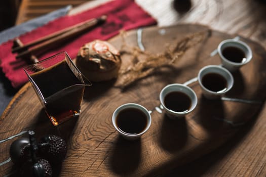 A warm and inviting tea setup displaying beautiful artisan cups and a charming teapot on a rustic wooden tray