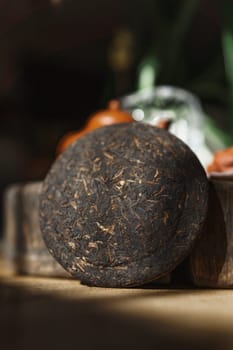 This is a closeup view of a compressed tea cake, showcasing its intricate texture and vibrant, rich colors