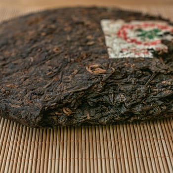 Explore this exquisite Puerh tea cake with earthy flavors and artisanal craftsmanship, ideal for tea lovers