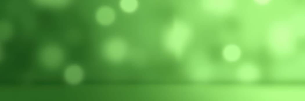 Soft green tones blend together to create a calming and vibrant abstract background. The bokeh effect adds depth and interest, perfect for design use.