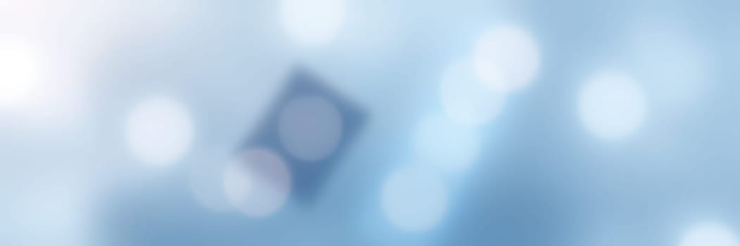 Soft blue background filled with light bokeh effects and abstract shapes. This design creates a calm and tranquil atmosphere, suitable for various digital projects or presentations.