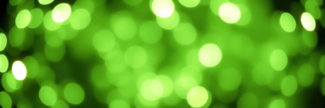 Soft green bokeh lights illuminate the dark surroundings, creating a tranquil and enchanting atmosphere. This captivating display evokes a sense of wonder and calmness.
