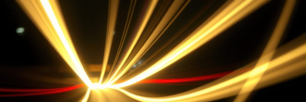 Light streaks illuminate the dark surroundings as vehicles move quickly along a bustling city road at night, creating a dynamic visual effect and an energetic atmosphere.