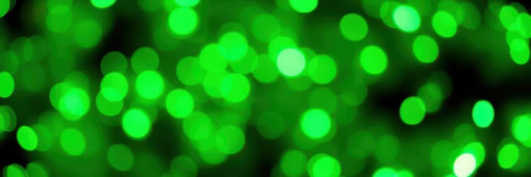 Sparkling bright green bokeh lights fill the background, creating a lively and festive atmosphere for an evening gathering or celebration.