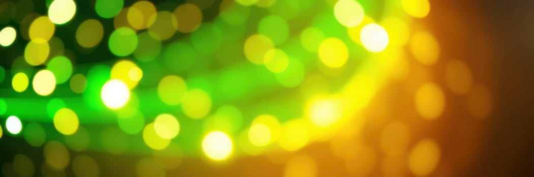 Bright bokeh lights shimmer in a blend of green and yellow hues, adding vibrant energy to an outdoor festival happening at night with people enjoying the celebration.