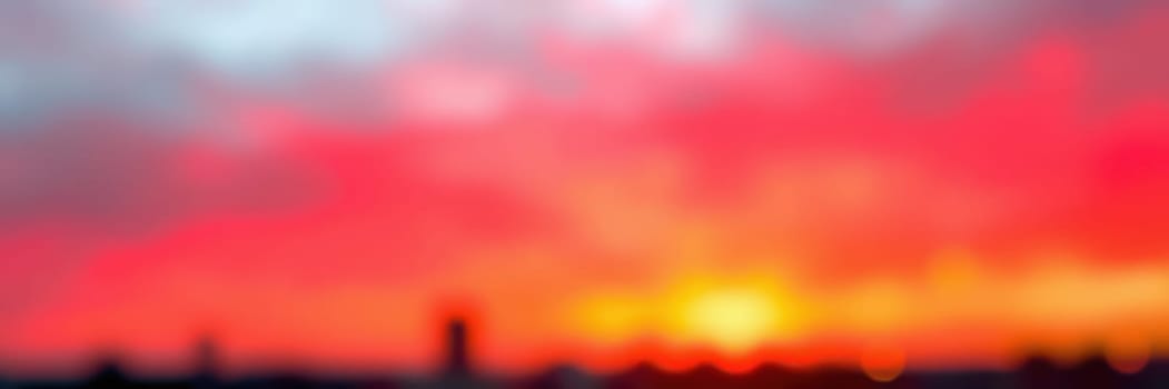 The skyline glows with a breathtaking sunset that paints the sky in shades of red, orange, and pink, evoking a serene and enchanting moment in the evening.