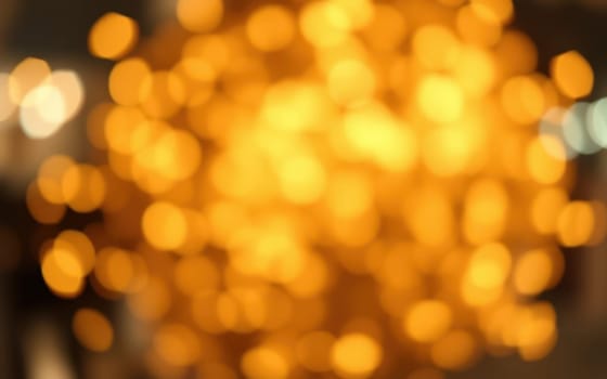 Warm, soft lights illuminate a cozy indoor space filled with a relaxing ambiance. The golden glow enhances the inviting atmosphere of an evening gathering.