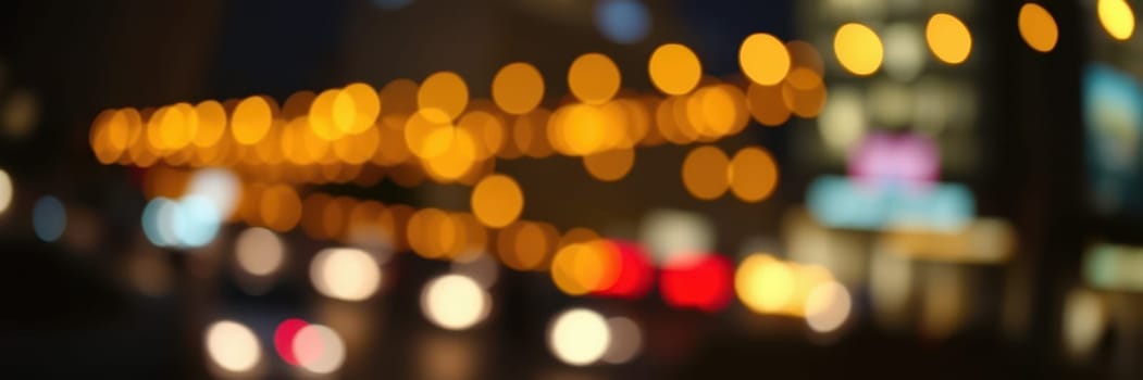 Glowing orbs of light illuminate a bustling city street, with blurred vehicles moving through the scene under the night sky, creating a vibrant urban atmosphere.