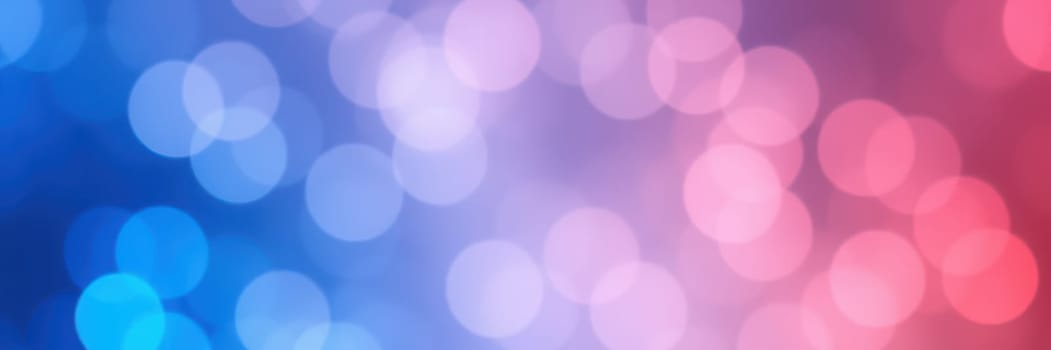 A vibrant bokeh background displays a blend of blue, pink, and purple hues. The soft circles of light create an out-of-focus effect, enhancing visual depth and appeal.