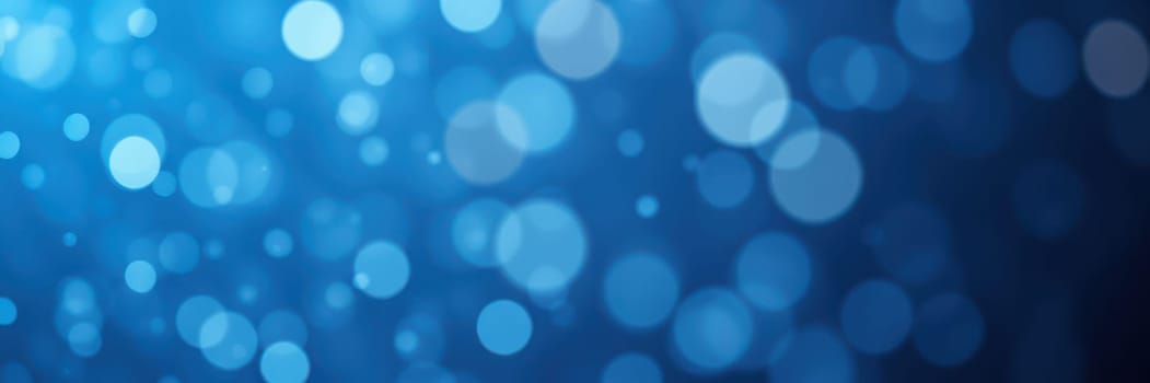 Soft blue bokeh lights float against a dark backdrop, creating a serene and dreamy atmosphere ideal for backgrounds or creative designs during evening events.