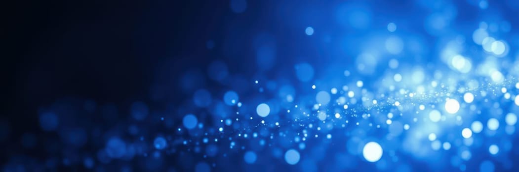 Bright blue bokeh lights sparkle against a dark background, creating a captivating and enchanting ambiance perfect for nighttime celebrations or events.
