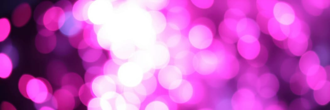 Vibrant bokeh lights in shades of pink illuminate a blurred background, creating a festive and enchanting ambiance ideal for parties or special occasions at nighttime.