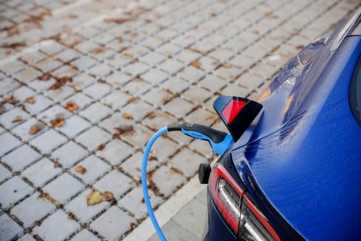 Cremona, Itally - October 6th 2024 Electric blue tesla model 3 long range, dual motor, all-wheel drive getting charged at a public charging station