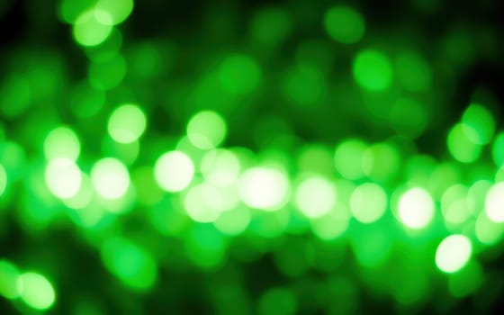 Vibrant green bokeh lights fill the background, creating a lively atmosphere that evokes feelings of joy and celebration during an outdoor event at night.