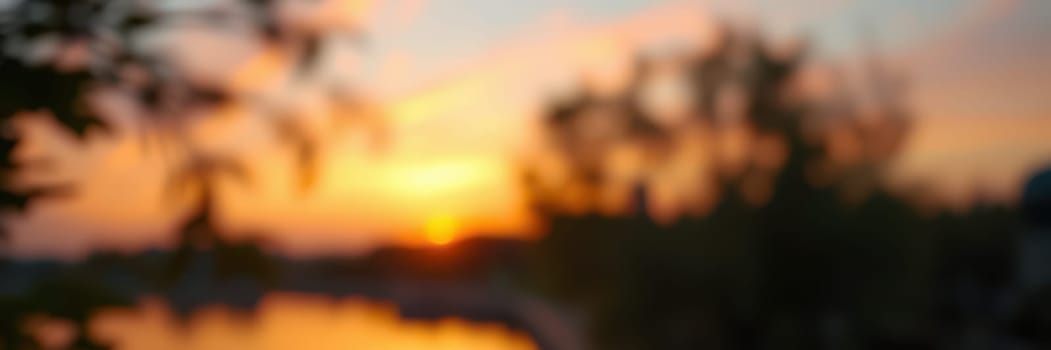 A warm sunset casts golden hues on calm waters, while silhouetted trees frame the horizon, creating a peaceful scene at dusk by the lakeside.