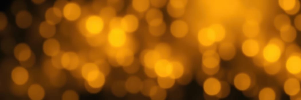 Soft golden bokeh lights fill the background, casting a warm glow over an evening gathering where friends and family celebrate together, enjoying the ambiance and each other's company.